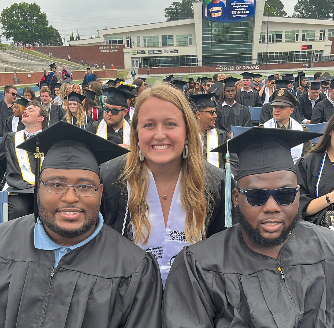 Photo of three students graduating